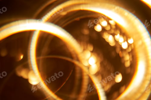 Preview: Abstract festive golden background with bright lines of light.