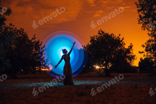Preview: Female silhouette in glowing circle in nature