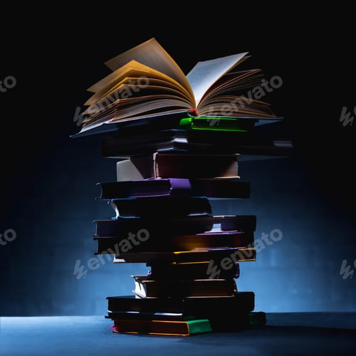Preview: stack of colored books with open book on top on dark surface