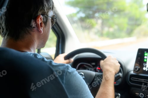 Preview: a male driver travels by car at the wheel