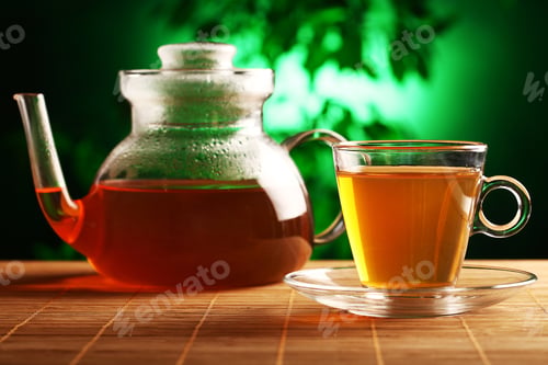 Preview: Hot green tea in glass teapot and cup