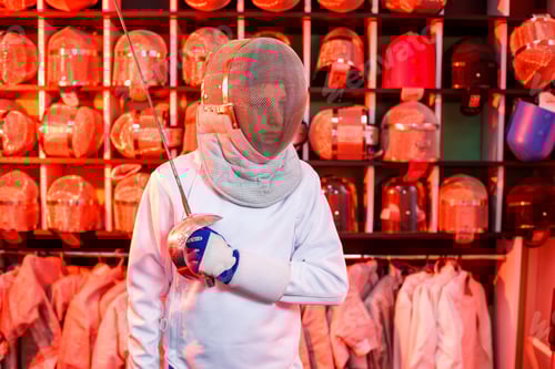 Preview: Young guy in a fencing suit with a sword in his hand, on a red background, neon light.