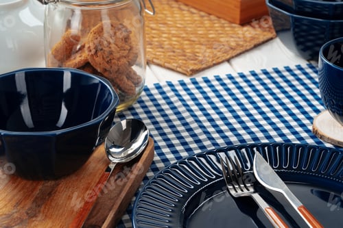 Preview: Deep blue ceramic plate with cutlery close up