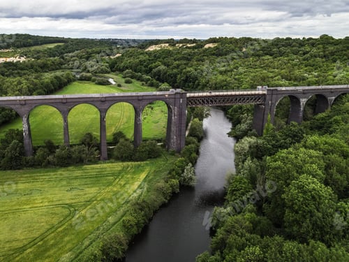 Preview: Aerial shot of railway Conisbrough Viaduct over the river Don surrounded by dense forest
