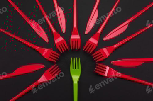 Preview: Disposable red and green plastic forks isolated on background