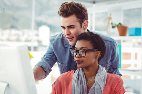 Preview: Creative business team working hard together in casual office