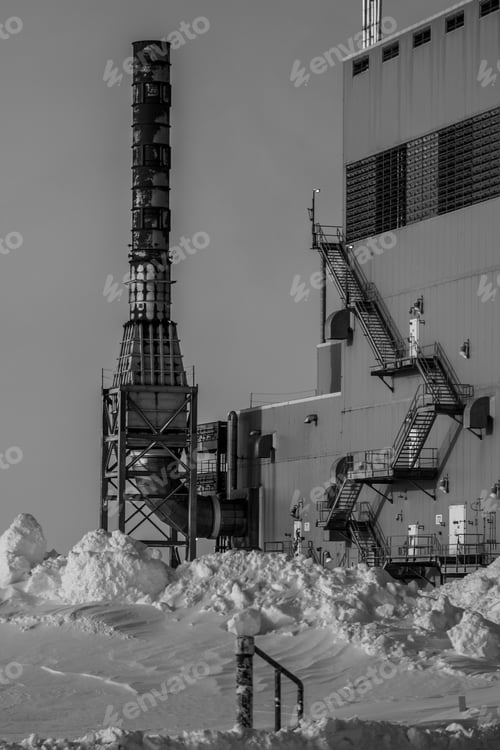 Preview: Vertical shot of a Factory in winter with a clear sky background