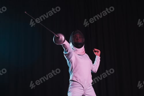 Preview: Low angle view of fencer training with rapier isolated on black