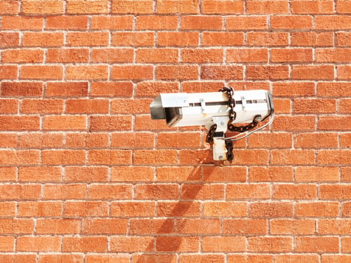 Preview: Surveillance camera on red brick wall