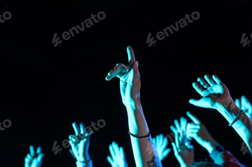 Preview: cropped view of hands on party in nightclub with blue back light
