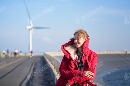 Preview: A Beautiful Woman Taking Selfies, wind turbine In Background