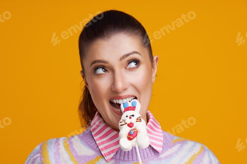 Preview: Studio shots of beautiful young woman over yellow background
