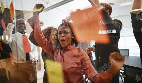 Preview: Ecstatic businesspeople dancing and cheering after an office brainstorming session