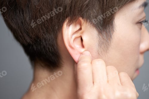 Preview: Middle-aged Japanese woman touching her earlobe