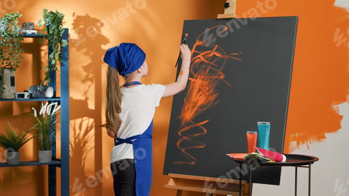 Preview: Small kid learning to paint design with aquarelle on canvas