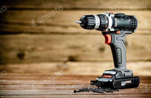 Preview: Cordless Drill with Screws on Wooden Table