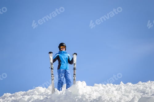 Preview: Woman skier on top of the mountain. Winter sports concept