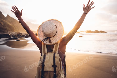 Preview: Woman walking on the beach enjoying sunset