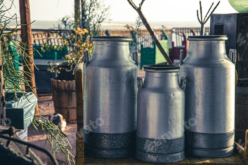 Preview: Old big aluminium milk cans close up.
