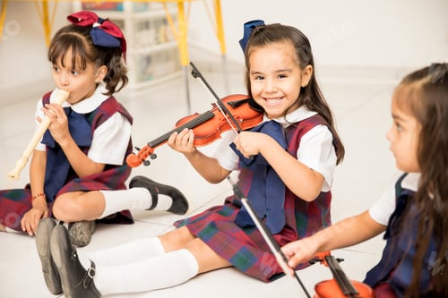 Preview: Happy girl playing the violin in preschool