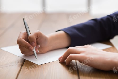 Preview: Woman signing papers, close up, side view,