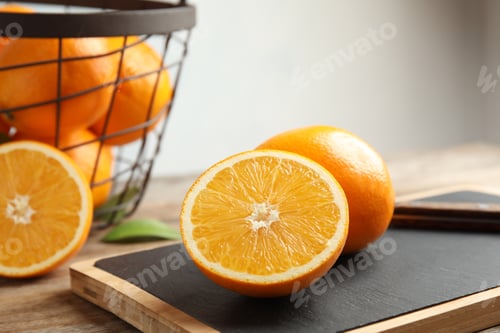 Preview: Fresh juicy oranges on cutting board. Healthy fruit