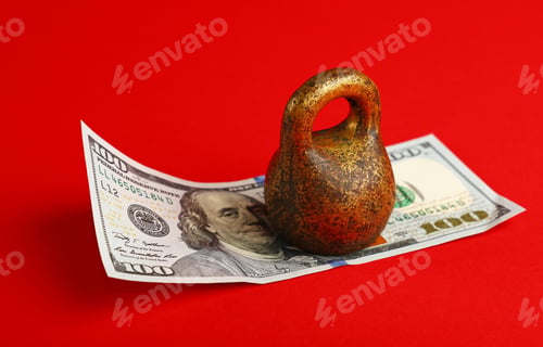 Preview: US dollar banknote under weight on red background