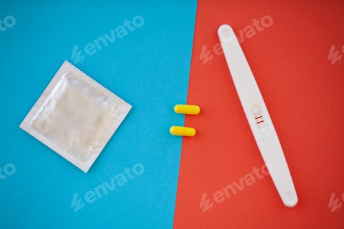 Preview: Pregnancy test. The result is positive with two strips and condom with contraceptive