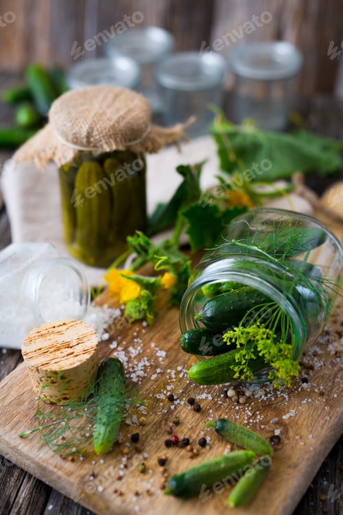 Preview: Jars of pickled marinated cucumbers on rustic table