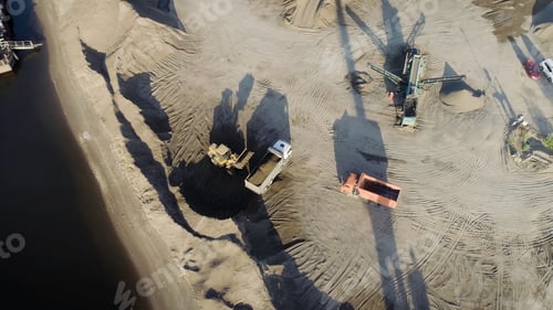 Preview: Aerial top view of trucks and machinery in the sand quarry. Scene. Sand pit, loading wagon sand