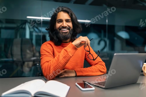 Preview: Happy indian businessman posing at modern office