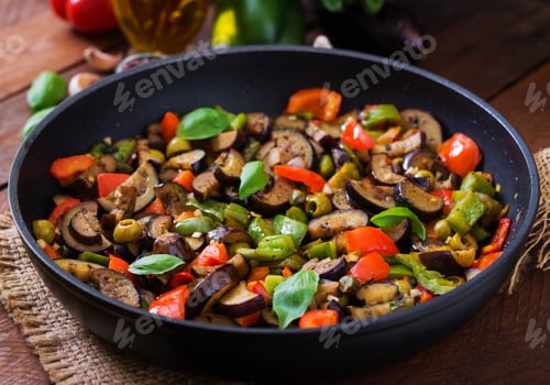 Preview: Hot spicy stew eggplant, sweet pepper, olives and capers with basil leaves.