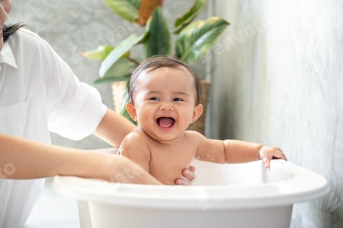 Preview: Adorable baby girl taking a bath with mother