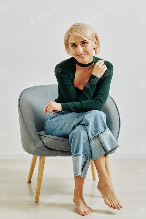 Preview: Blonde Young Woman Sitting in Armchair