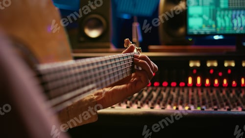 Preview: Skilled artist singing on his guitar and recording tunes for a future song