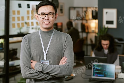 Preview: Portrait of Young Adult Caucasian Man Standing Confidently in Modern Office