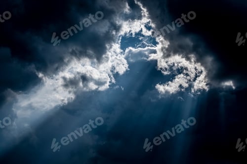 Preview: Bright rays of sun make their way through dark cloud.