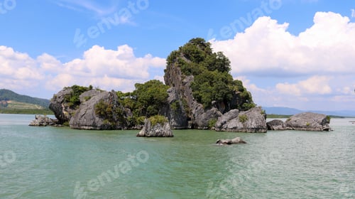 Preview: Beautiful view of rock formations by the lake under a cloudy sky