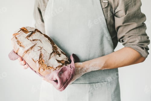 Preview: Baker or chef holding fresh made bread
