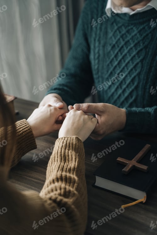Preview: Asian men and women hands praying to god with the bible.