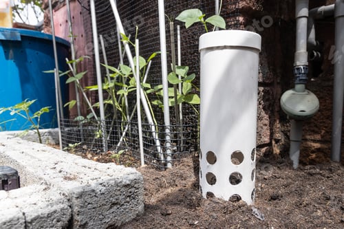 Preview: Worm tower with drilled holes placed in garden against plants