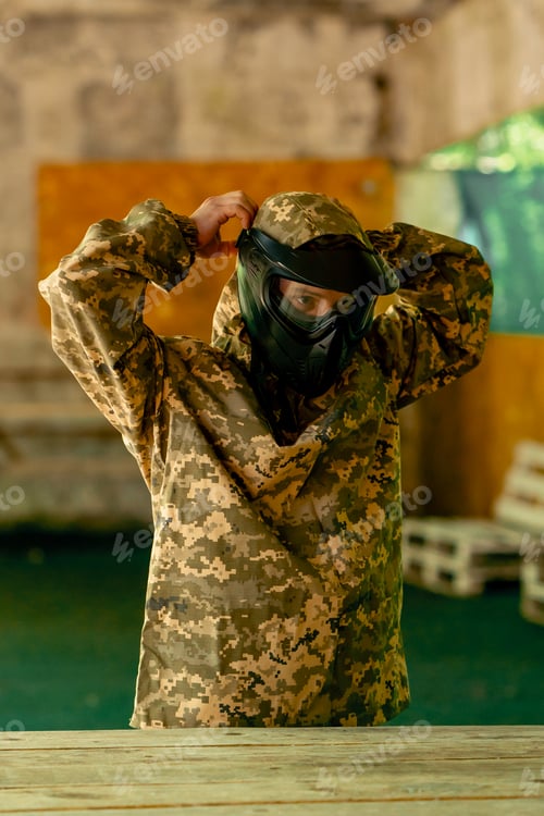 Preview: in the wild in the hangar for instructions a pintball coach puts on a uniform before the game full