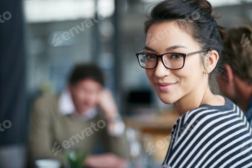 Preview: Closeup portrait of an attractive young office worker in a meeting