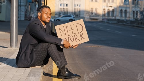 Preview: Desperate disgruntled African American millennial student wearing suit sitting on steps outdoors