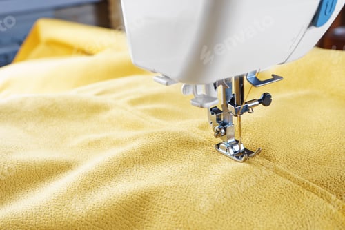 Preview: Modern Sewing Machine With Yellow Velours Fabric Close Up