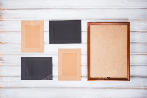 Preview: picture frames of different colors and wooden background
