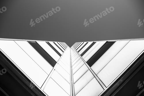 Preview: Low angle grayscale shot of a building under a clear sky