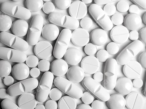 White Pills and Capsules in Orderly Arrangement