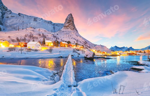 Preview: Dramatic winter sunset view on Hammarskaftet Mountain Peak with footbridge above Gravdalbukta bay .