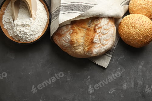 Preview: Flat lay composition with fresh bread and space for text on grey table